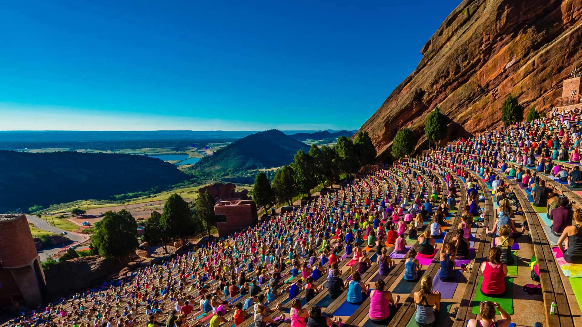 Yoga practitioners at Red Rocks Amphitheatre in Colorado